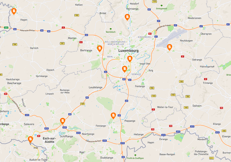 Map of Luxembourg showing Basic-Fit club locations marked with orange &ldquo;B&rdquo; icons, located in and around Luxembourg City, Esch-sur-Alzette, Differdange, and nearby towns such as Bertrange, Kirchberg, and Howald.