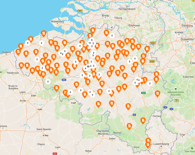 Map of Belgium and surroundings showing Basic-Fit club locations, marked with orange &ldquo;B&rdquo; icons densely spread across Flanders, Brussels, and Wallonia.