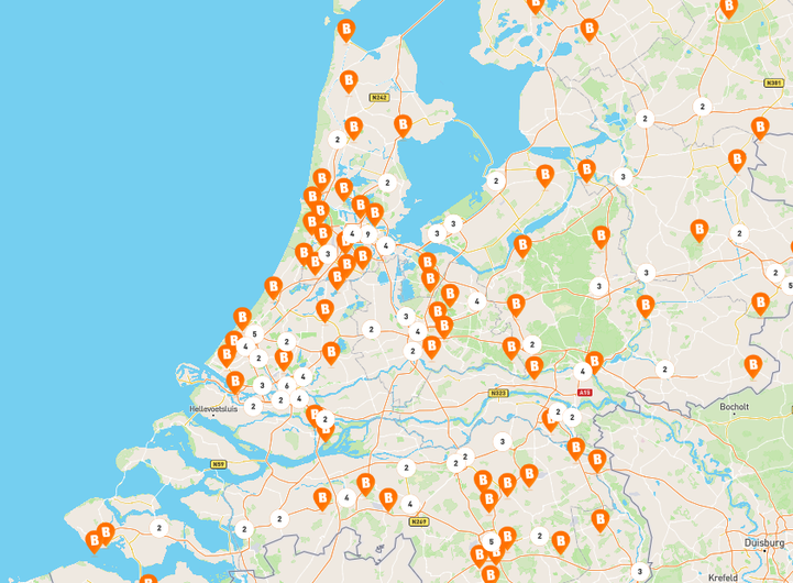 Map of the Netherlands showing multiple Basic-Fit gym locations, with orange &ldquo;B&rdquo; icons clustered around major cities including Amsterdam, Rotterdam, The Hague, and Utrecht.